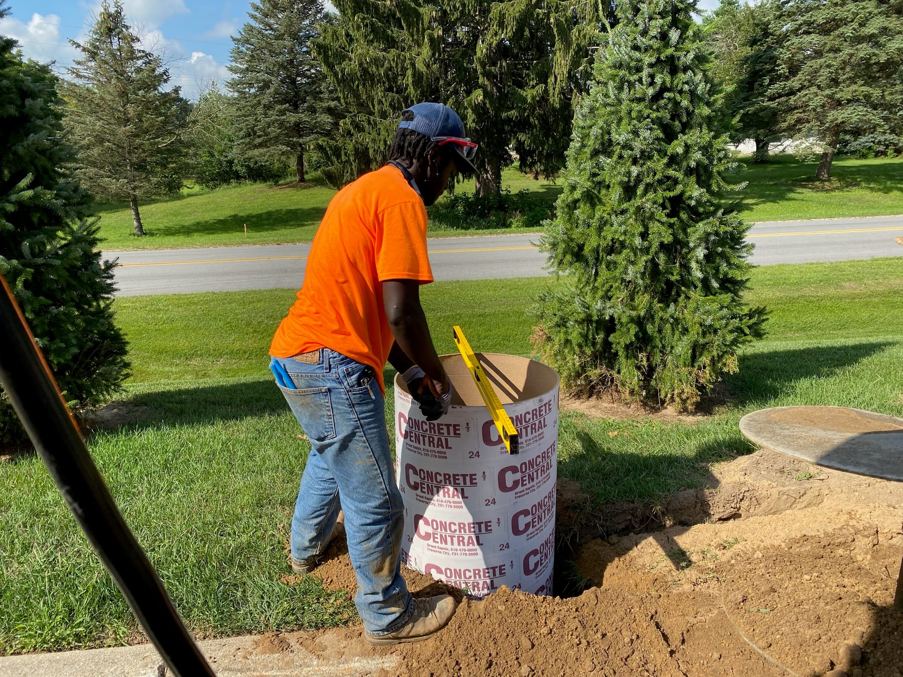 A Fine Line electrician setting a post base on a residential site